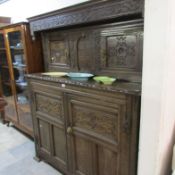 A carved oak court cupboard