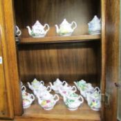 A collection of approximately 30 miniature teapots