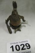 A miniature metal and nut kernel figure