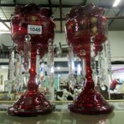 A pair of ruby glass lustre vases