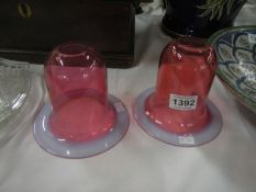 A pair of cranberry glass lamp shades