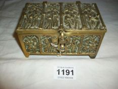 A decorative brass casket