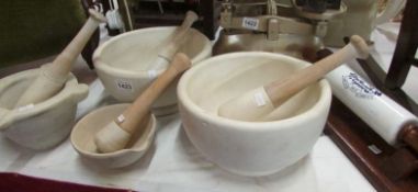4 pestle and mortars and a McDougal's rolling pin
