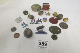 A mixed lot including buttons, badges, horse shoe locket etc