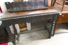 A carved oak console table and a mirror