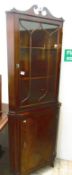 A mahogany glazed corner cupboard