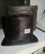 A top hat in hat tin (inside of hat worn)