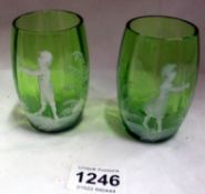 A pair of Mary Gregory green glass tumblers