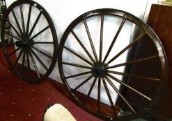 A pair of large old cart wheels