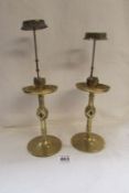 A pair of Eccliastical brass candlesticks with shade holders