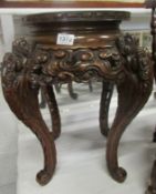 A carved wood Oriental stand