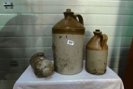 A stoneware hot water bottle and 2 stoneware jars