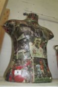 A bust/manikin decorated with decoupage of footballers
