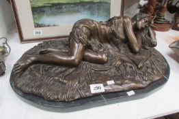 A bronze reclining lady