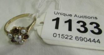 A 9ct gold ring set garnets and pearls