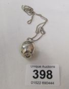 A silver apple necklace