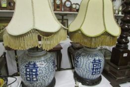 A pair of blue and white table lamps with shades