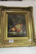 A gilt framed still life of fruit signed Johnny Gaston