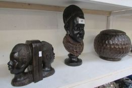 A carved African bust, pair of bookends and lidded wooden pot
