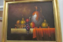 A still life oil painting of fruit signed Wallace
