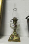 A Victorian Wright and Butler oil lamp with cut glass font and painted base