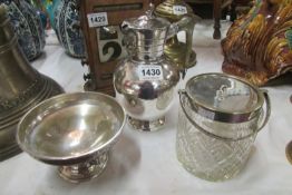 A silver plated claret jug, a glass biscuit barrel and a dish