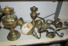 A mixed lot of oil lamps, wall lamps etc