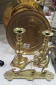 A pair of brass candlesticks, 2 brass plates and a wall bracket