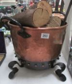 A copper log bin with logs