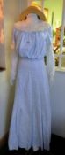 A blue and white Edwardian style summer dress with straw boater