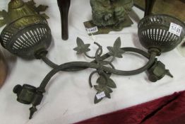 A pair of Art Nouveau brass wall oil lamp brackets