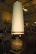 A large pottery table lamp with shade