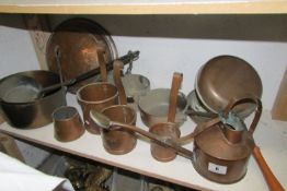 A mixed lot of copper and brass pans and measures (1 shelf)
