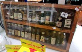 27 miniature whiskies in display case