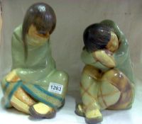 A pair of Lladro figures being boy and girl sleeping