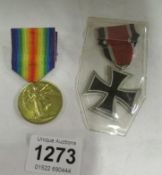 An iron cross (restrike) and a WW1 medal