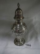 A silver sugar sifter