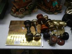 A quantity of brass and other doorknobs and door plates