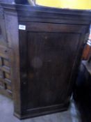 An oak corner cupboard