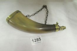 A horn powder flask with brass fittings