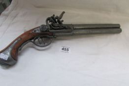 A replica double barrelled flintlock pistol