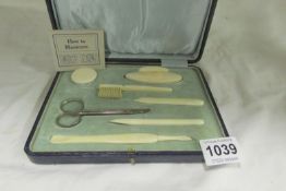 A cased ivory manicure set