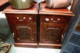 A pair of mahogany bedside cabinets