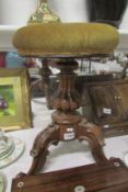 A Victorian mahogany revolving piano stool