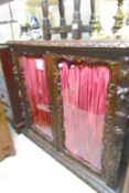 An early carved oak cabinet with glazed doors