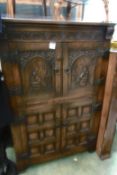 A Breton style carved oak cabinet