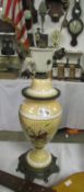 A Victorian lamp base with butterfly motif