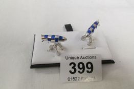 A pair of silver and enamel cuff links