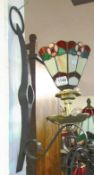 An iron wall light with Tiffany style shade