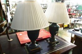 A pair of urn shaped table lamps with shades